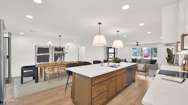 5109 E Blanche Dr, Scottsdale, AZ 85254 - kitchen with a sink, open floor plan, dishwasher, a kitchen bar, and light wood-style floors