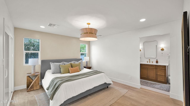 5109 E Blanche Dr, Scottsdale, AZ 85254 - bedroom with light wood-type flooring, multiple windows, baseboards, recessed lighting, and ensuite bathroom