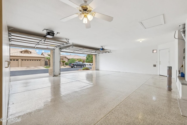 garage with a garage door opener and ceiling fan