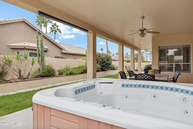 exterior space featuring a jacuzzi and ceiling fan