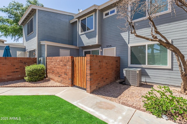 2301 E University Dr Unit 233, Mesa, AZ 85213 - view of front of home with central AC unit, fence, and a gate