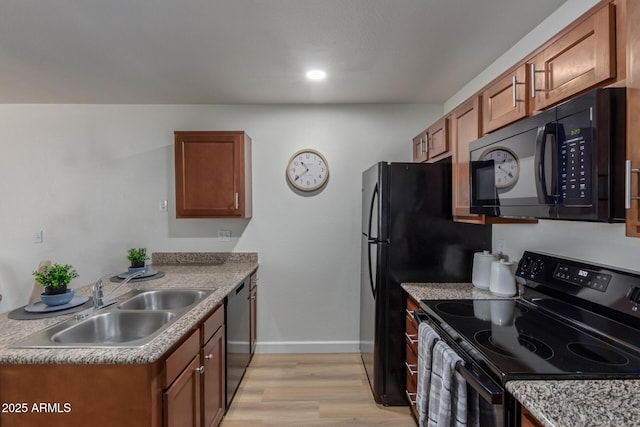 2301 E University Dr Unit 233, Mesa, AZ 85213 - kitchen with black appliances, a sink, baseboards, and brown cabinets