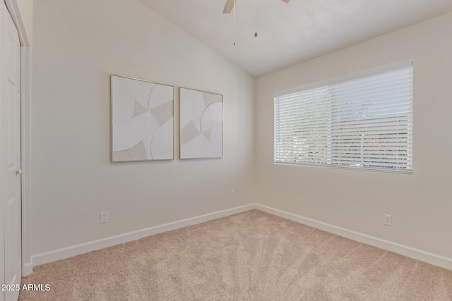 2301 E University Dr Unit 233, Mesa, AZ 85213 - empty room featuring carpet floors, ceiling fan, vaulted ceiling, and baseboards
