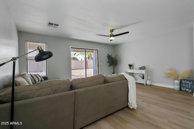 living room featuring hardwood / wood-style floors and ceiling fan