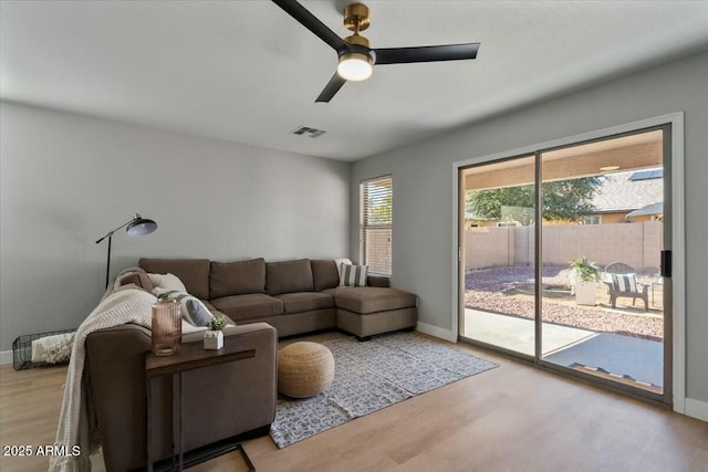 living room with ceiling fan and light wood-type flooring