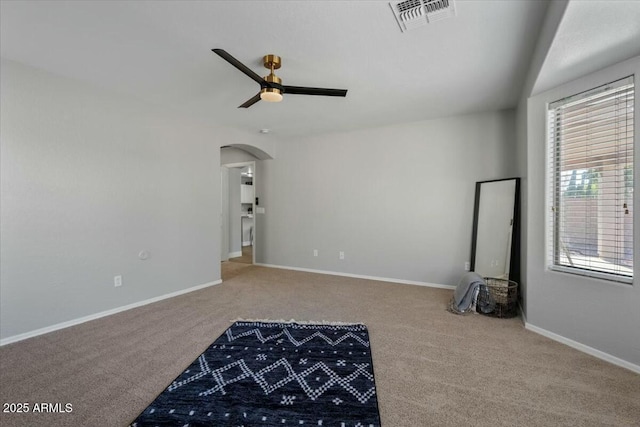 spare room with carpet floors and ceiling fan