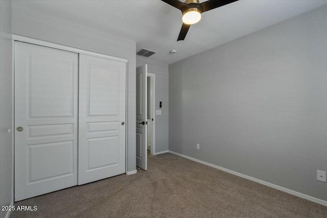 unfurnished bedroom with light carpet, a closet, and ceiling fan