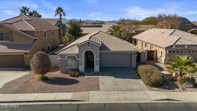 view of front of house with a garage and a mountain view