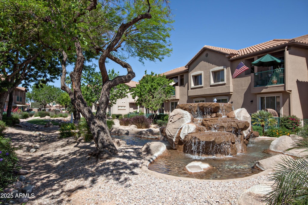 view of home's community featuring a garden pond