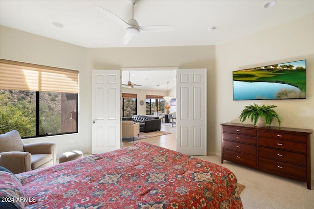 bedroom with ceiling fan and light colored carpet