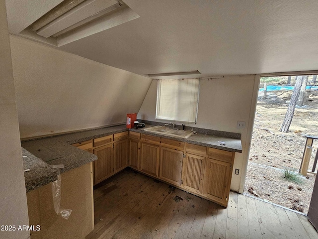 kitchen with vaulted ceiling, sink, and dark hardwood / wood-style flooring