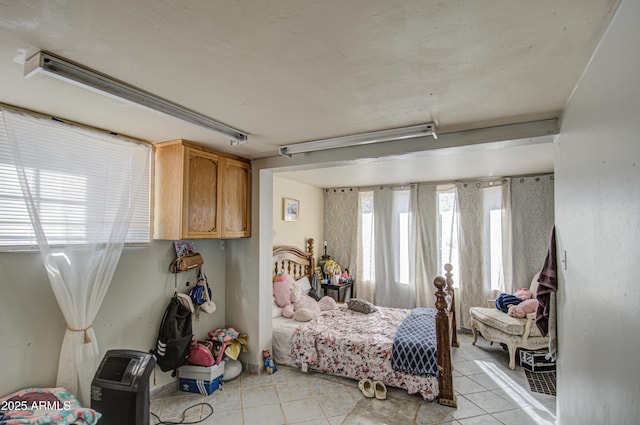 bedroom featuring light tile patterned flooring