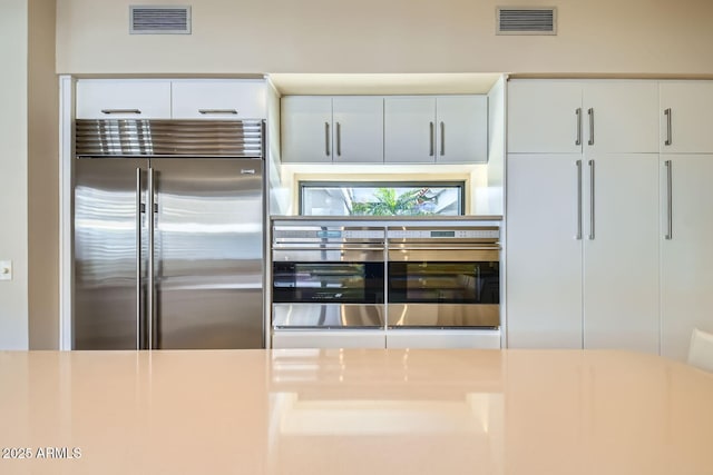 kitchen featuring white cabinetry and appliances with stainless steel finishes