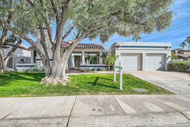 view of front of property with a garage and a front yard