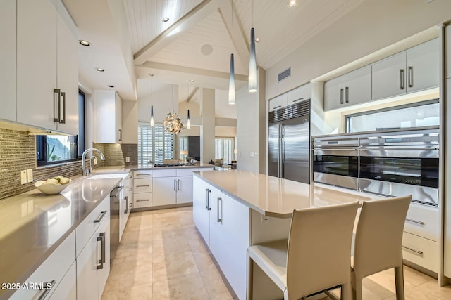 kitchen with white cabinetry, appliances with stainless steel finishes, and a center island