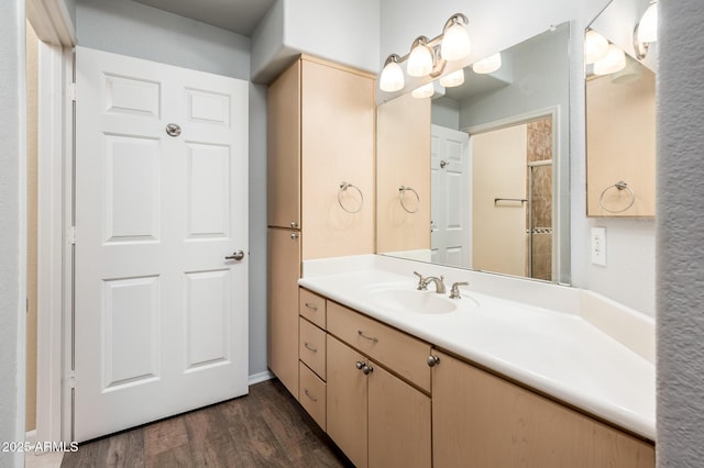 full bathroom featuring vanity and wood finished floors