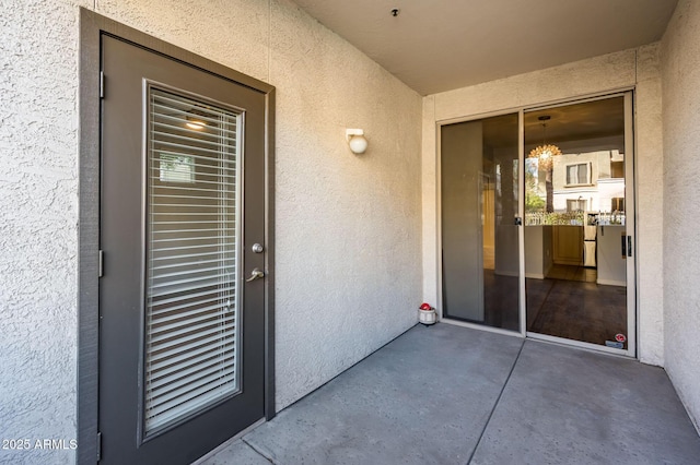 entrance to property with stucco siding