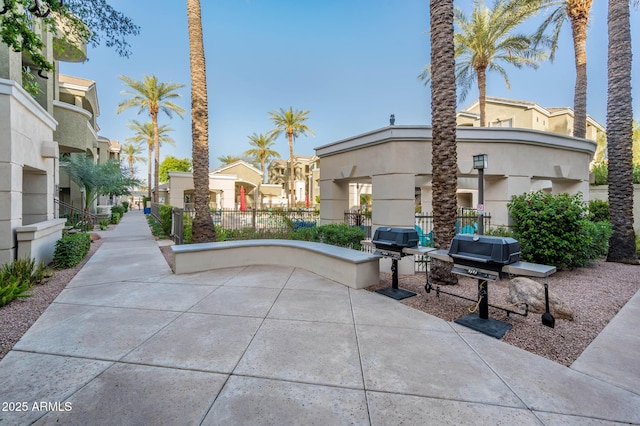 surrounding community with fence and a residential view