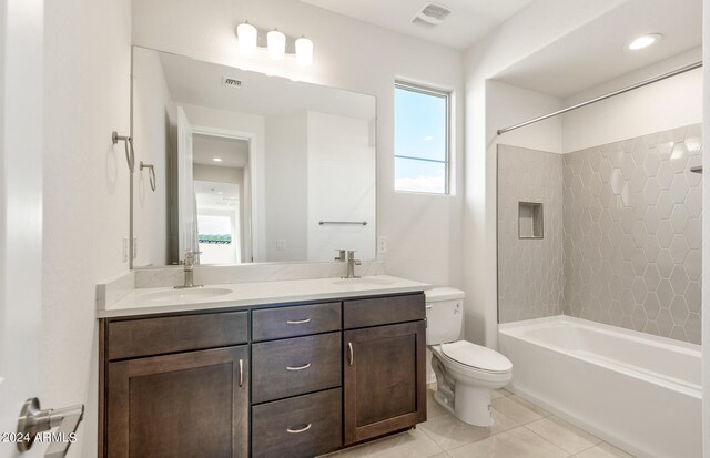 full bathroom with tile patterned floors, vanity, toilet, and tiled shower / bath combo