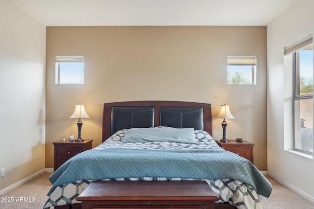 bedroom with light carpet and baseboards