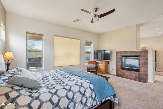 bedroom with a fireplace, visible vents, multiple windows, and carpet