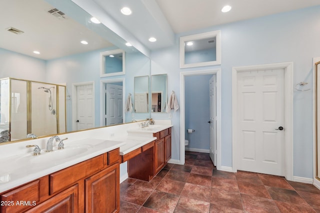 full bath featuring a shower stall, visible vents, toilet, and a sink