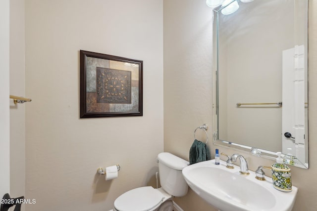 half bathroom with a sink and toilet