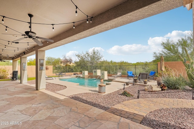 view of swimming pool with a patio, a fenced in pool, a fenced backyard, and a ceiling fan