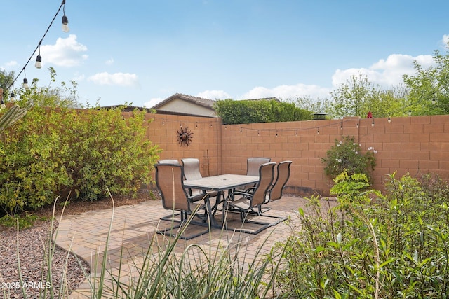 view of patio featuring outdoor dining area and a fenced backyard