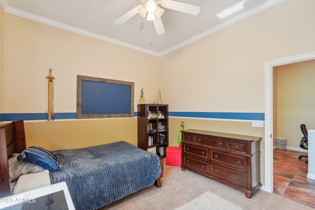 carpeted bedroom featuring baseboards, ceiling fan, and ornamental molding