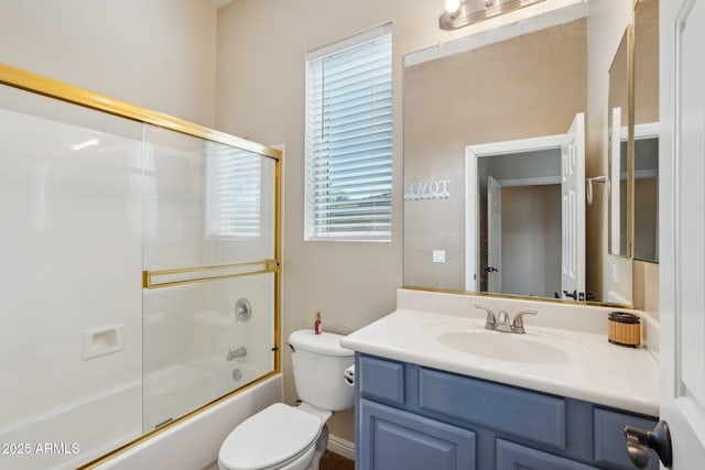 full bath featuring toilet, shower / bath combination with glass door, and vanity