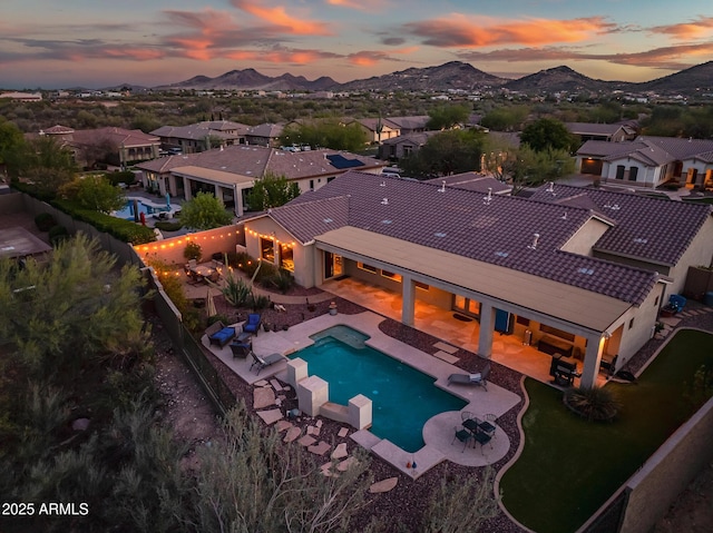 view of pool featuring a fenced backyard, a patio, a mountain view, and a fenced in pool