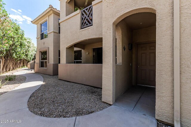 9550 E Thunderbird Rd Unit 149, Scottsdale, AZ 85260 - doorway to property with stucco siding and fence