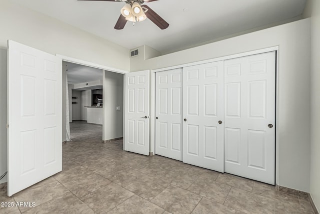 9550 E Thunderbird Rd Unit 149, Scottsdale, AZ 85260 - unfurnished bedroom with a ceiling fan, a closet, light tile patterned floors, baseboards, and visible vents