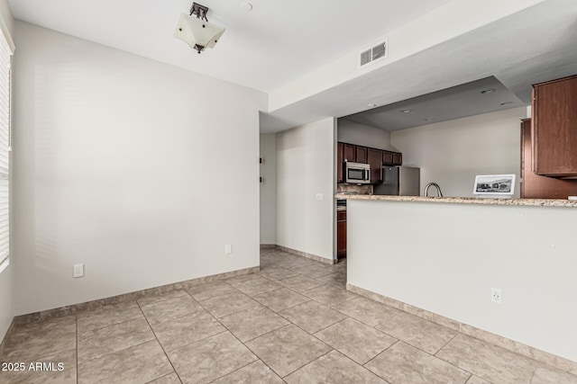 9550 E Thunderbird Rd Unit 149, Scottsdale, AZ 85260 - unfurnished living room featuring baseboards, visible vents, a sink, and light tile patterned flooring