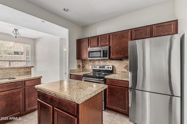 9550 E Thunderbird Rd Unit 149, Scottsdale, AZ 85260 - kitchen with a sink, tasteful backsplash, appliances with stainless steel finishes, light stone countertops, and light tile patterned floors