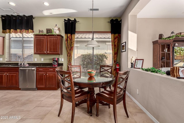 dining area featuring sink and a wealth of natural light