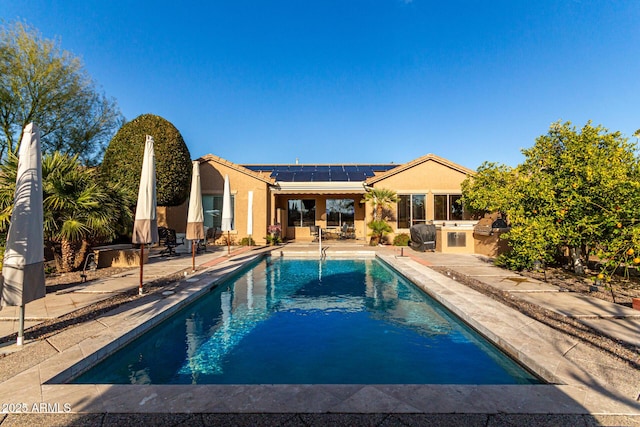 view of swimming pool featuring area for grilling and a patio area