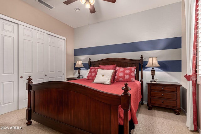 carpeted bedroom with a closet and ceiling fan