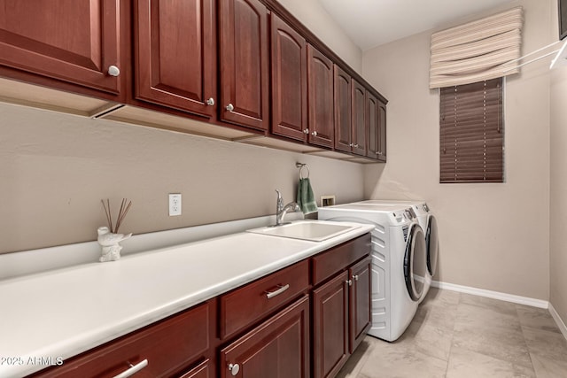 washroom featuring cabinets, sink, and washer and dryer