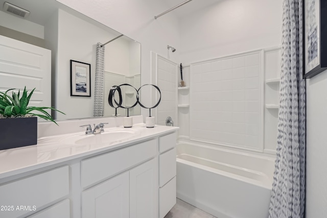 bathroom with visible vents, vanity, and shower / bath combo