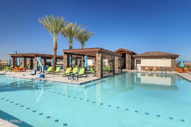 pool with a patio area and a pergola