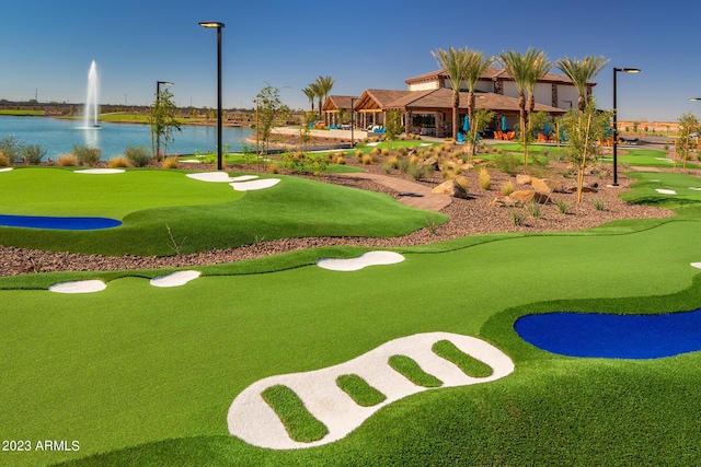 view of home's community with golf course view and a water view