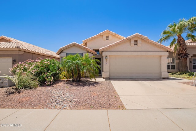 4441 E Desert Wind Dr, Phoenix, AZ 85044 - view of front facade with a garage, driveway, stucco siding, and a tiled roof