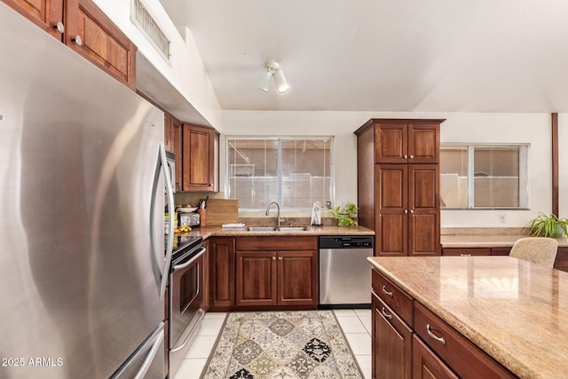 4441 E Desert Wind Dr, Phoenix, AZ 85044 - kitchen featuring stainless steel appliances, a sink, light tile patterned floors, and light stone countertops