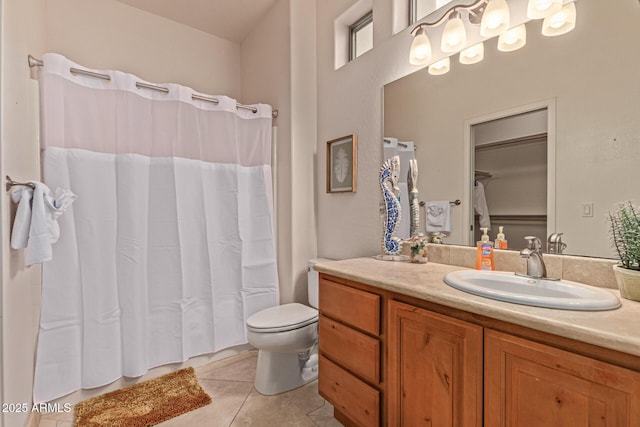 bathroom featuring tile patterned flooring, vanity, a shower with shower curtain, and toilet