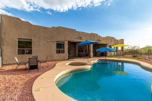 view of pool featuring a patio and an in ground hot tub