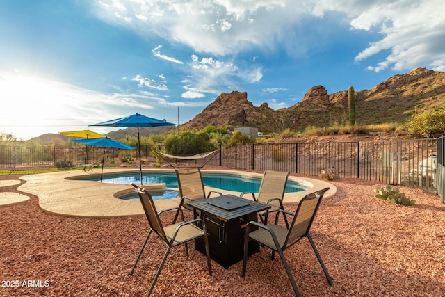 view of pool with a mountain view and a patio area