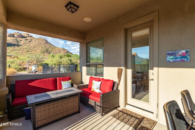 exterior space with an outdoor living space, a mountain view, and a balcony