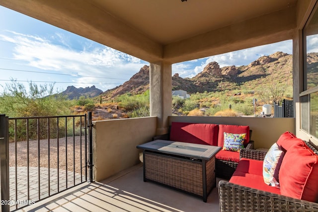 balcony featuring a mountain view and outdoor lounge area